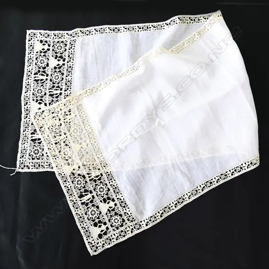 An antique table runner with reticella lace trim.